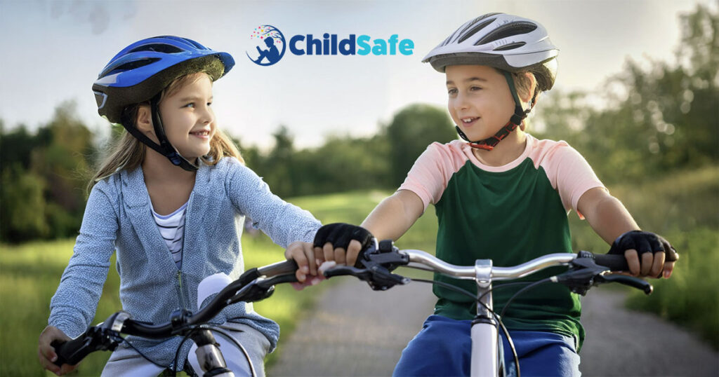 Boy and girl on bikes wearing helmets