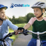 Boy and girl on bikes wearing helmets