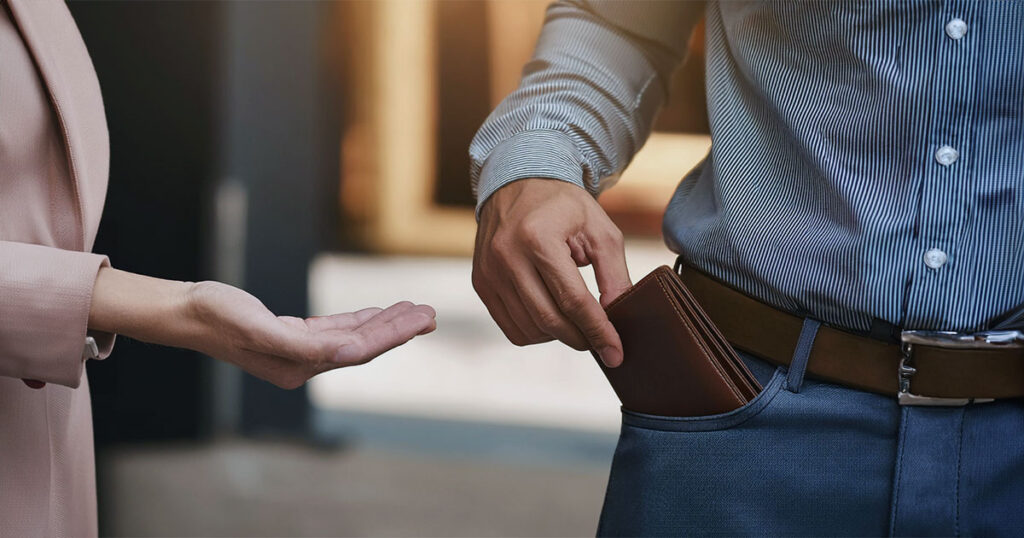 Man getting wallet to give to woman